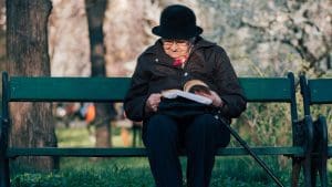Lady reading a book on a bench