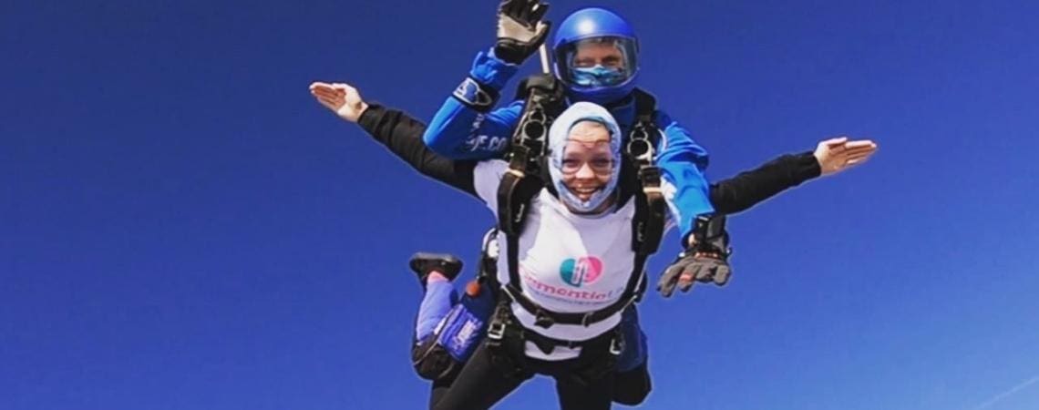 Two people skydiving while wearing Dementia UK t-shirts