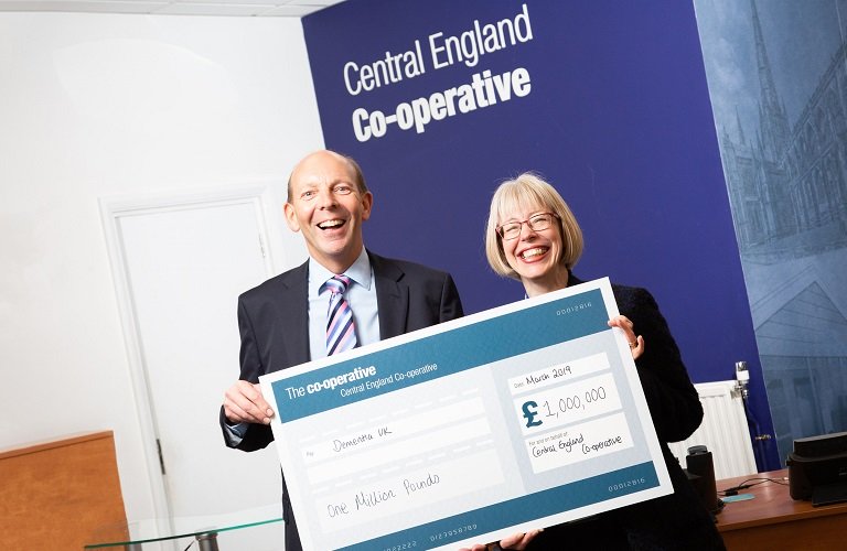 Hilda from Dementia UK and Martyn from the Co-op celebrate a donation