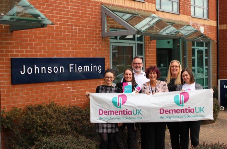 Volunteers hold a Dementia UK banner