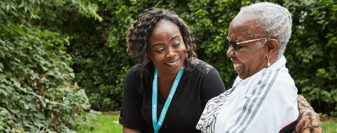 A woman laughs with an Admiral Nurse