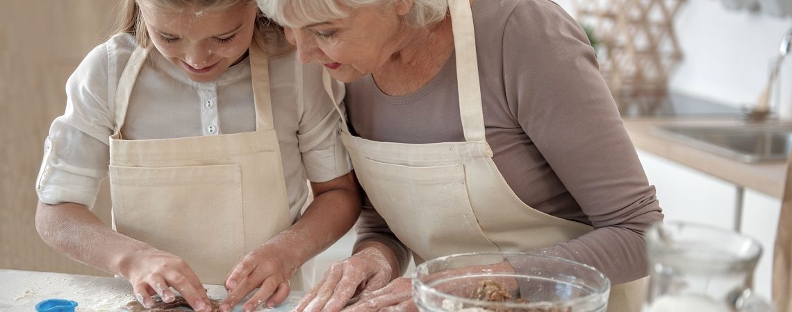 A grandmother and her child bake together