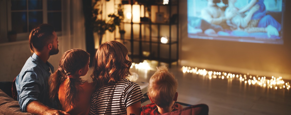 A family watching a movie together at home.