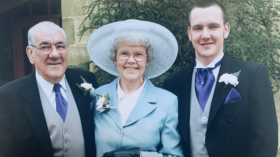 Chris stands with his mother and father on his wedding day