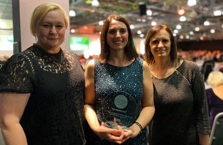 Three women from St Cuthbert's Hospice team accepting an award