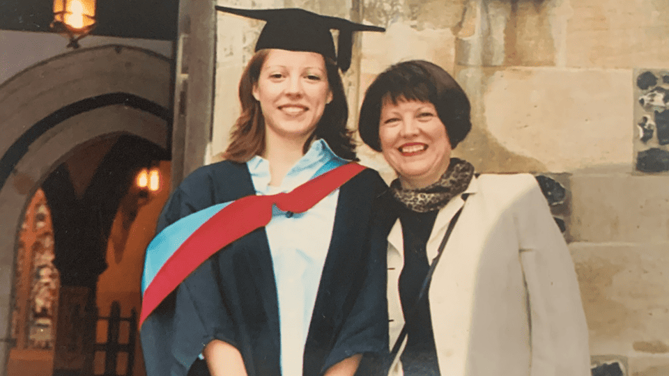 Admiral Nurse Hannah is pictured in her graduation gown from university, standing next to her mother Susan.