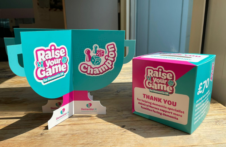 Dementia UK Raise your Game branded collection box and trophy
