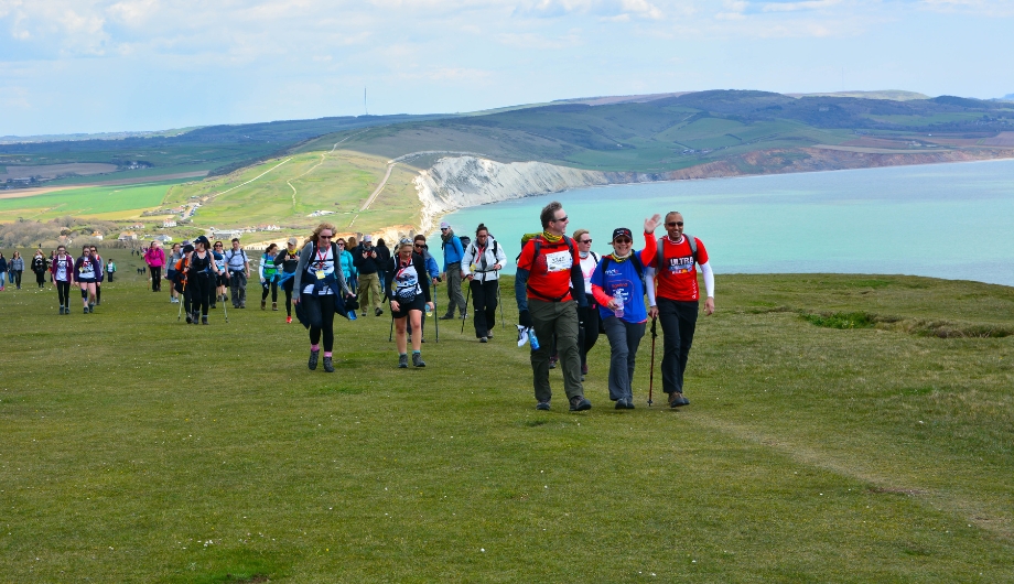 Large crowd of people walking along the Isle of Wight coastline