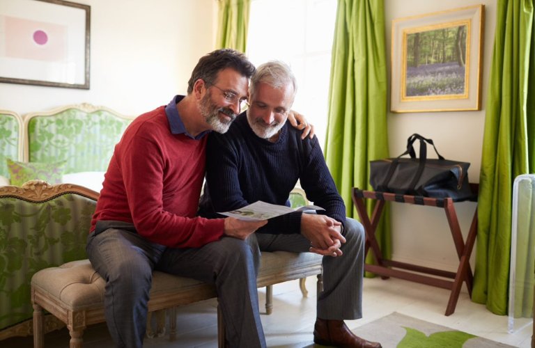 A couple at home reading a leaflet about Dementia