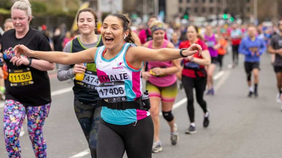 people running a marathon and cheering as they reach the finish line