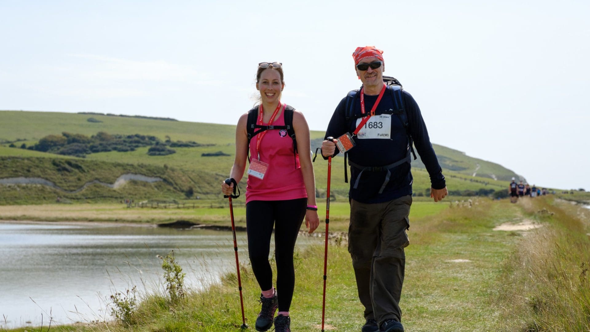 Woman and man walking by a lake