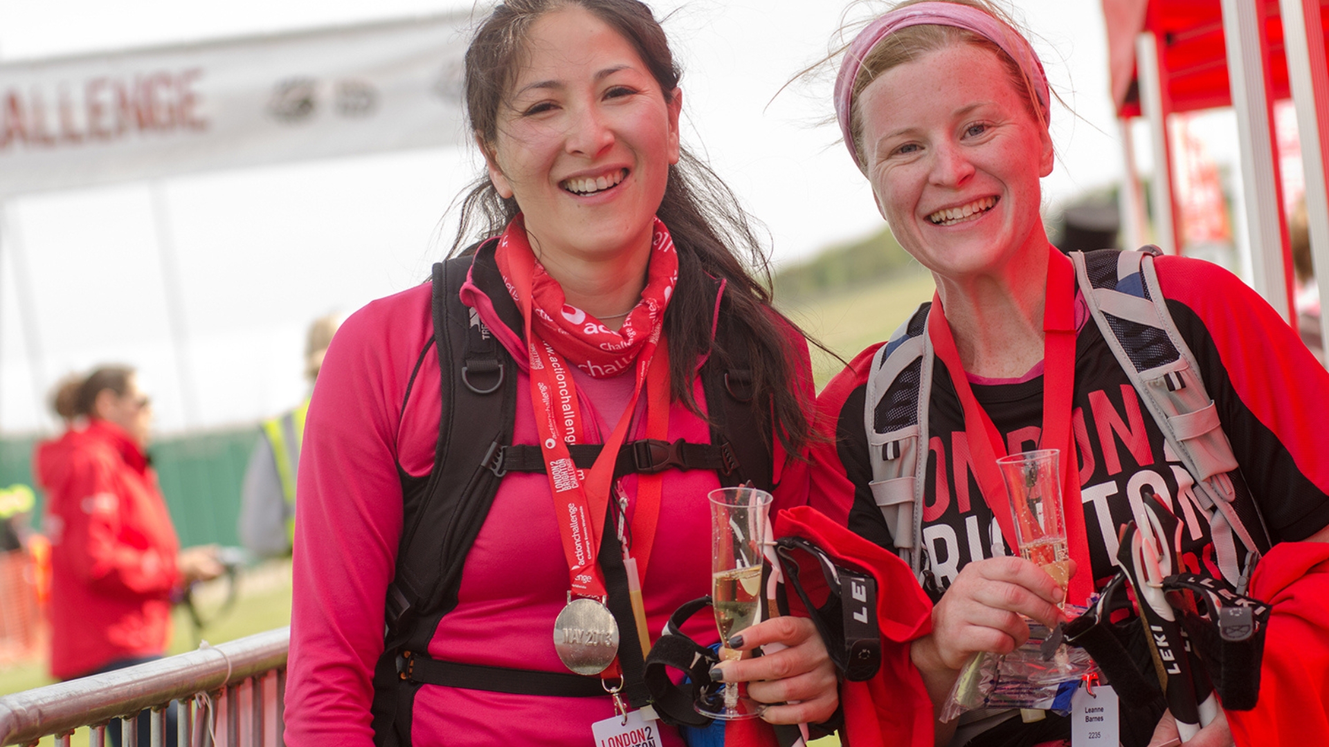 Two women who have completed the challenge and are wearing medals