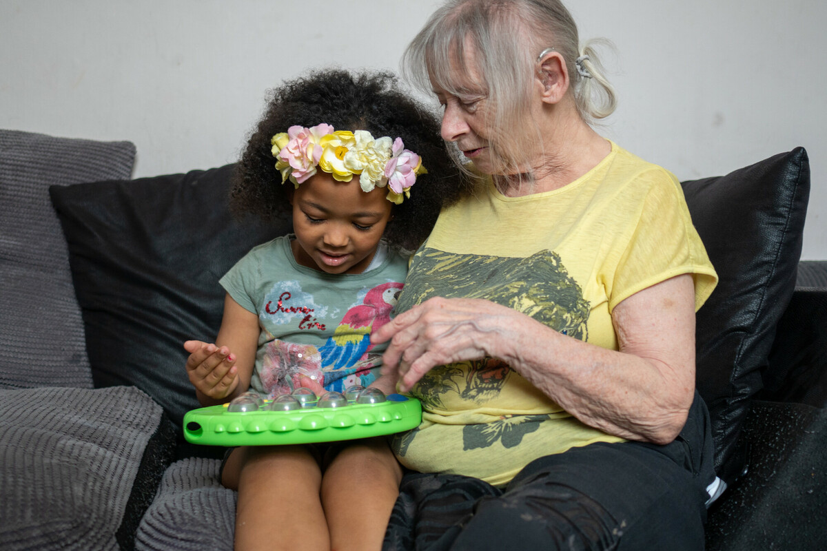 An older woman shares a moment with a child.