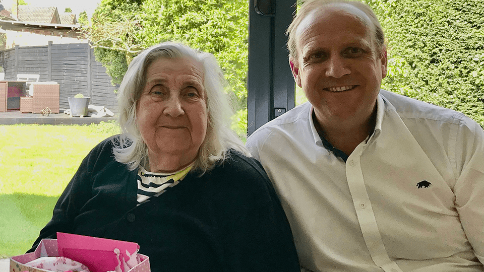Steve sits alongside his Mum at the family home