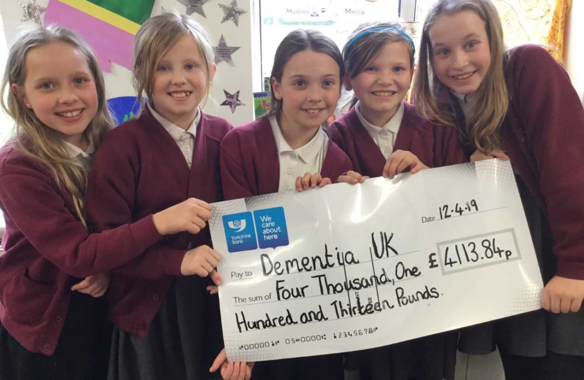 five children from Todmarden Primary School holding a cheque for Dementia UK