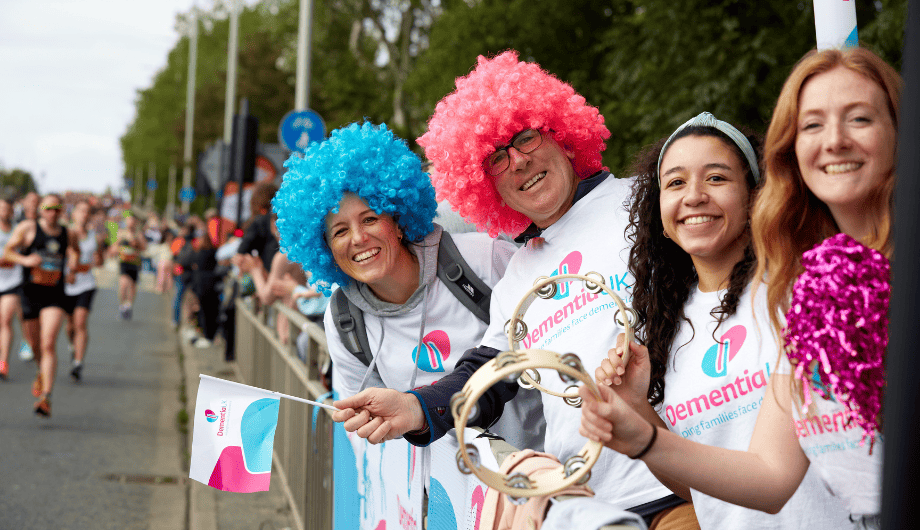 Four Dementia UK volunteers cheering on runners at London Marathon