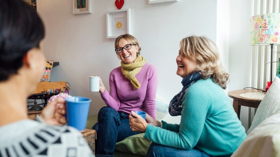 three women sitting together and talking