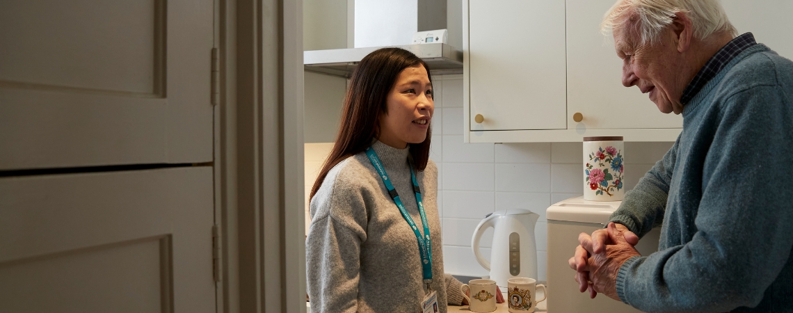 Admiral Nurse in kitchen with family carer