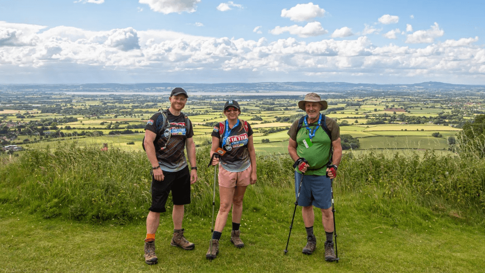 three people taking on the Kent Downs 50 Ultra challenge with their walking gear