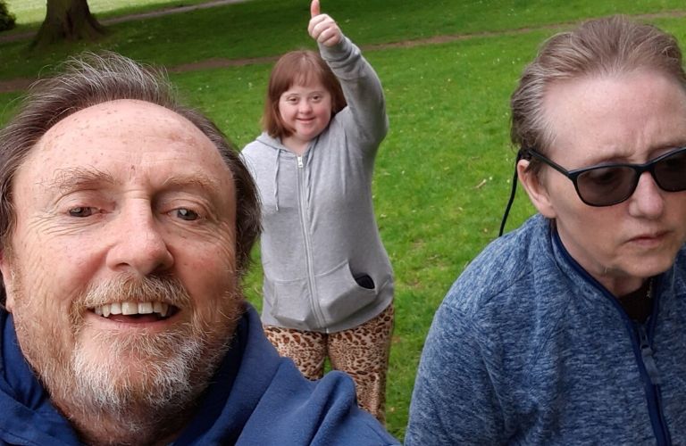 John and Linda with their daughter Katie, taking a selfie outdoors