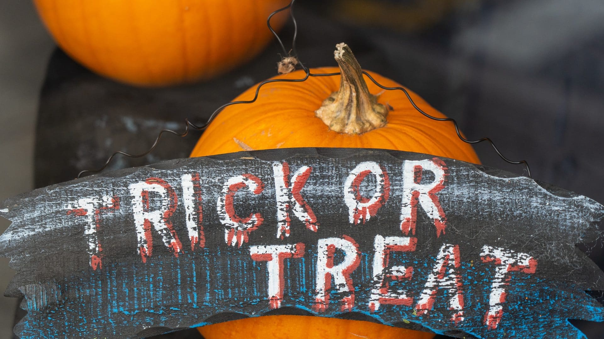 pumpkins and a trick or treat sign.