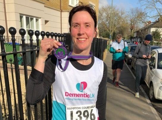 Helen shows her medal for running.