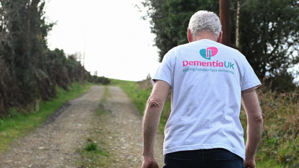 supporter wearing a dementia uk t shirt participating in a walking challenge