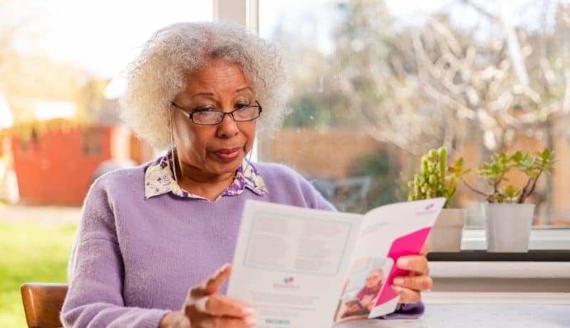 woman reading one of Dementia UK's leaflets